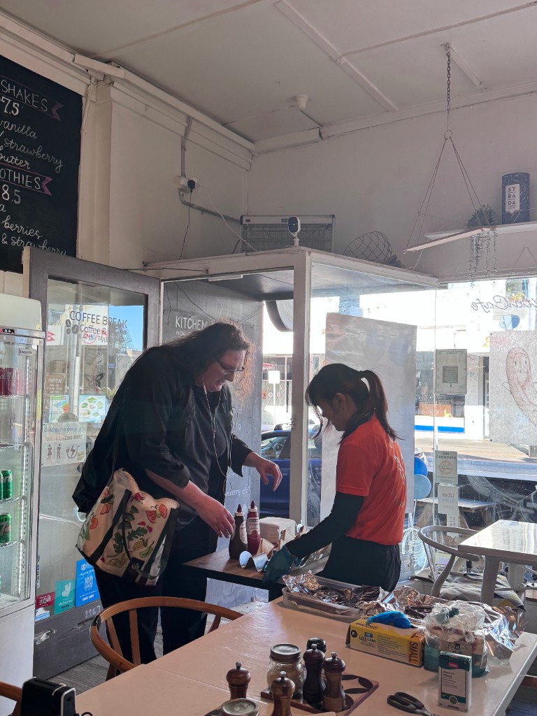 Staff serving customers at the community café